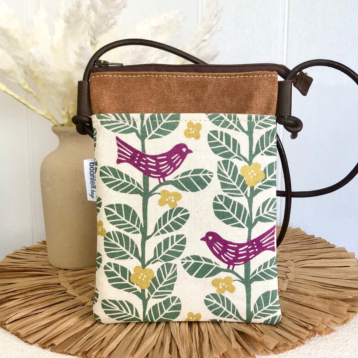 brown canvas phone sling with bird