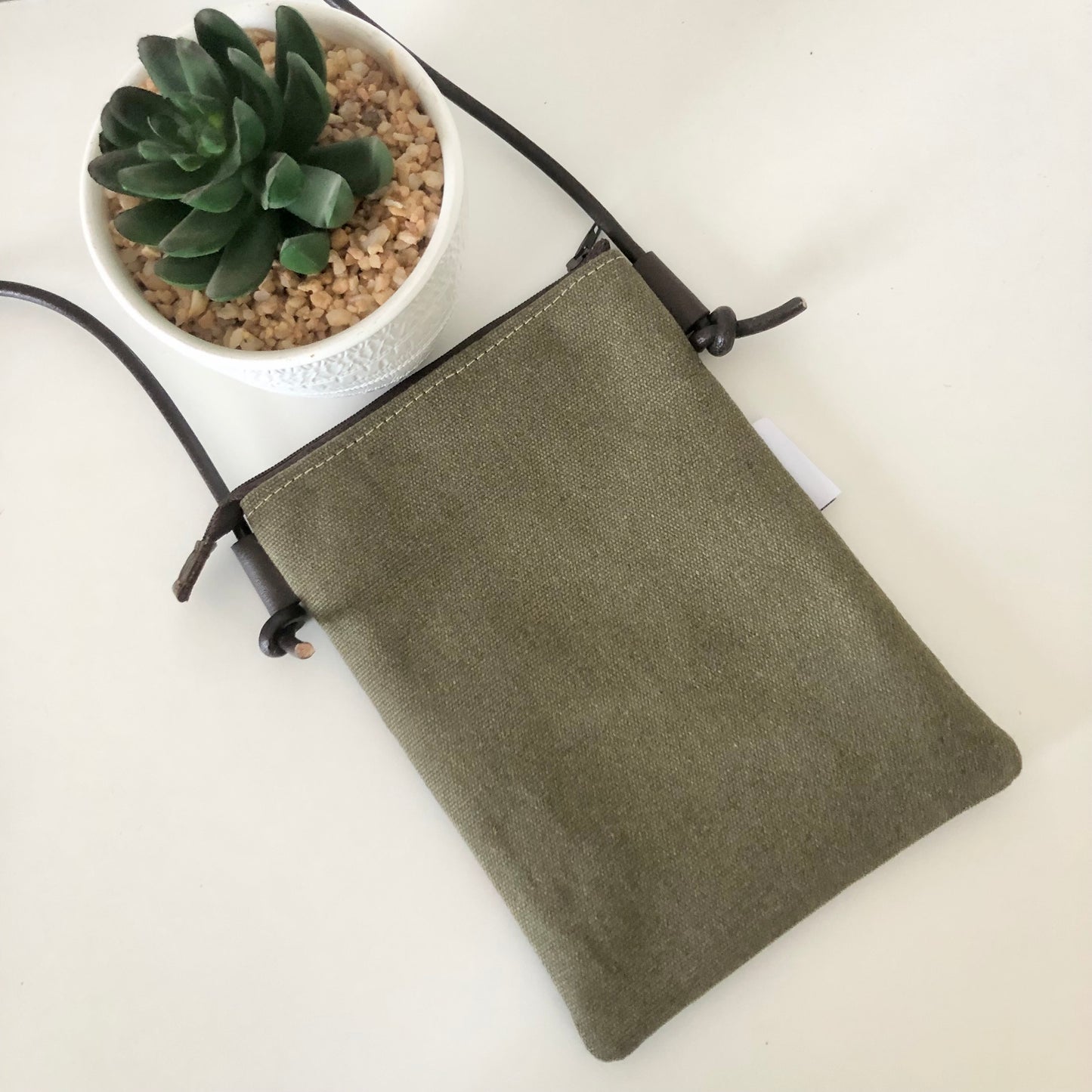 green canvas phone sling back view