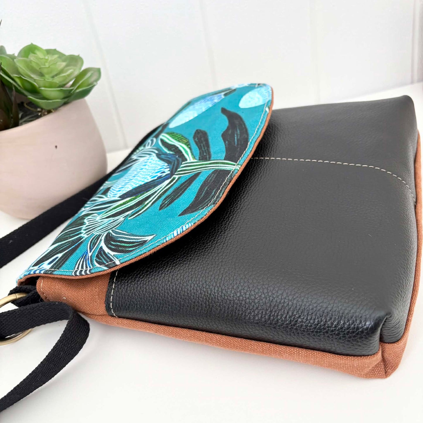 Cassinia Crossbody Bag -Tan Canvas and Black Leather with Blue Banksia