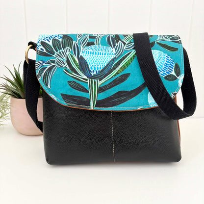 Cassinia Crossbody Bag -Tan Canvas and Black Leather with Blue Banksia