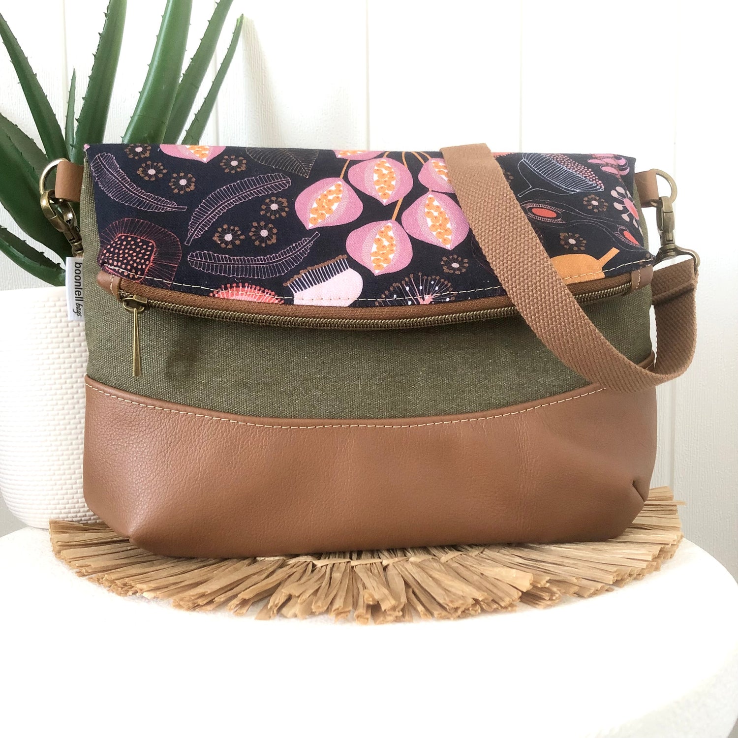 fold over bag front in seed pod and leather