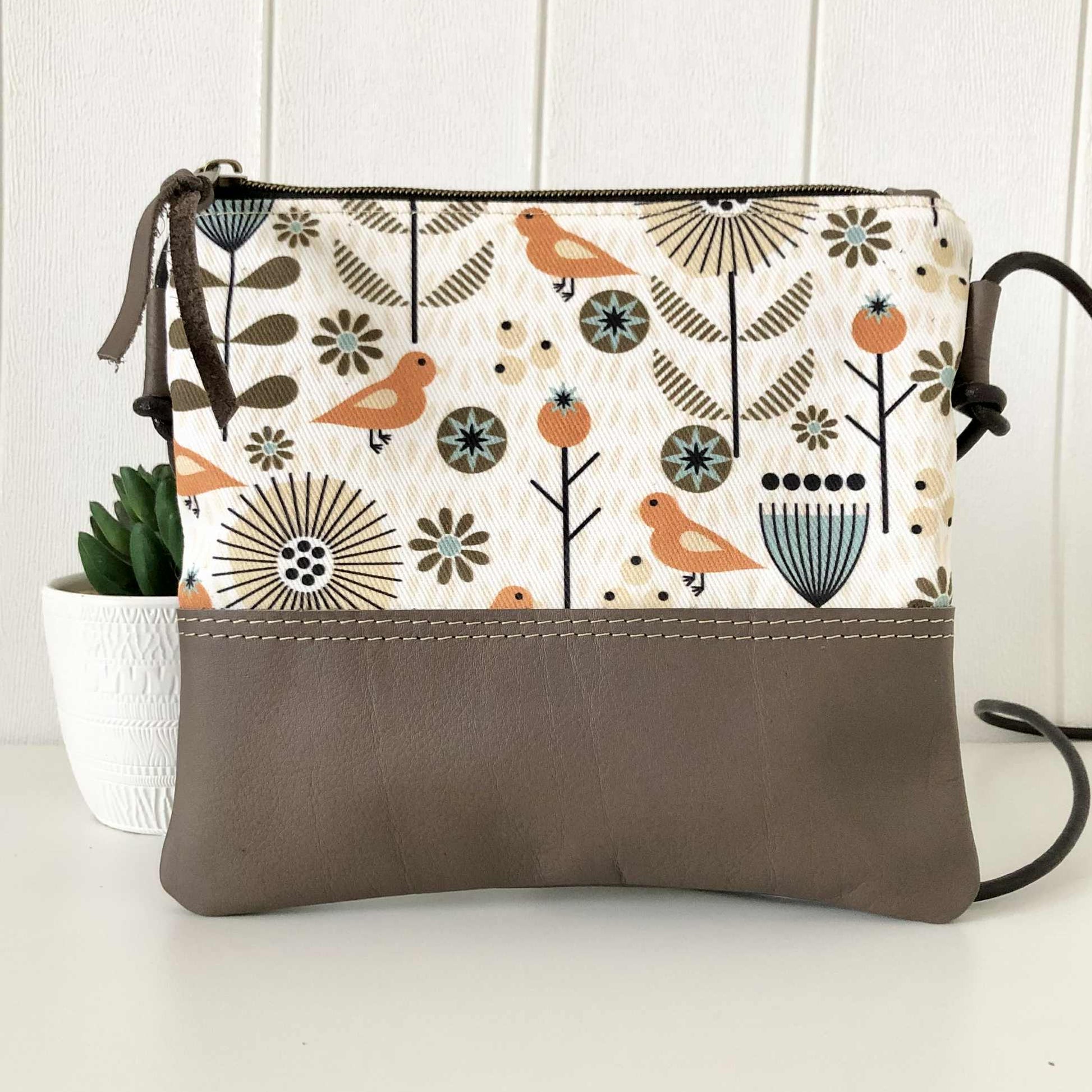 bird fabric and brown leather sling bag